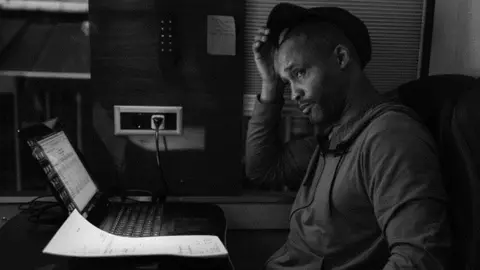 Simon Peter Green Divine checking the hotel bills