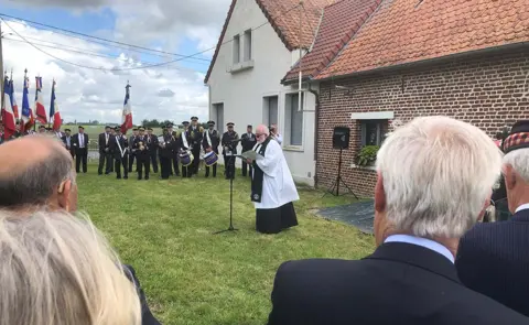 Shaun Peel/BBC An outdoor service in Lestrem near Lille, commemorating the massacre's 80th anniversary