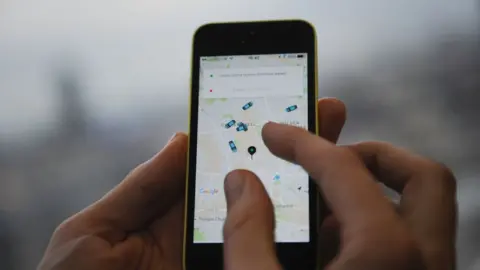 Getty Images Uber app on phone