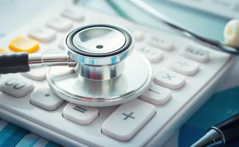 Getty Images A stethoscope on a calculator