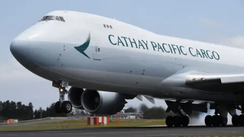 Getty Images A Cathay Pacific Cargo Boeing 747 aircraft lands at Sydney Airport.