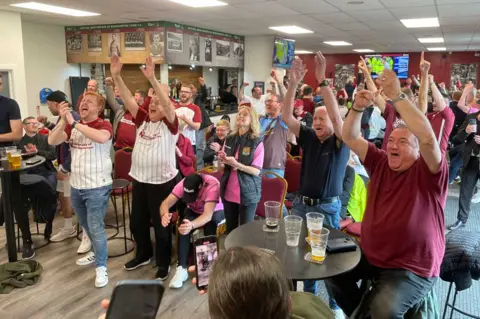 James Burridge/BBC Northampton fans celebrate at Sixfields