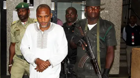 Getty Images Nnamdi Kanu (C) attends a trial for treasonable felony at the Federal High court in Abuja, on February 9, 2016.