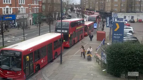 A line of more than a dozen buses queuing in traffic along the A23, pictured at 4pm on Monday