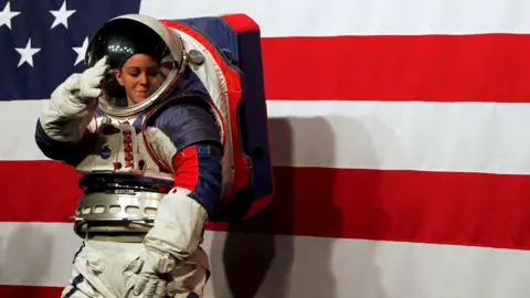 Advanced Space Suit Engineer Kristine Davis wears the xEMU prototype space suit during its presentation at NASA headquarters