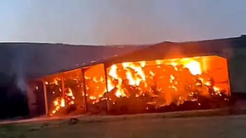 Jamie Trapp  A large roadside barn alight.