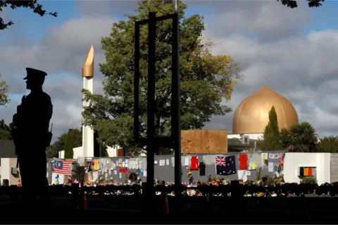 Reuters Christchurch: Officer stands guard by Al-Noor Mosque