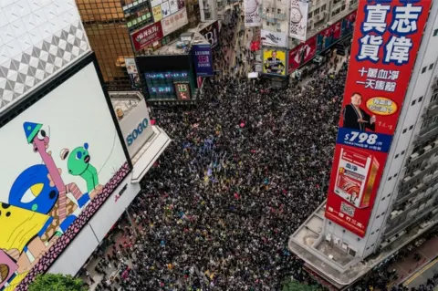 Getty Images An aerial shot shows thousands of protesters filling a street for a rally on New Year's Day in Hong Kong