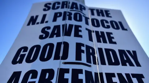 Reuters A poster reading: "Scrap the NI Protocol, Save the Good Friday Agreement" at the port of Larne in Northern Ireland