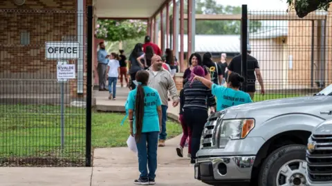 Getty Images Parents and students at an Uvalde school