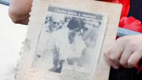 Reuters Leila carrying a picture of the kiss