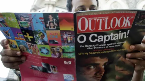 Getty Images Man reading about the Ganguly-Chappell spat