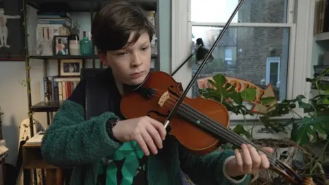 BBC Arthur at home playing violin