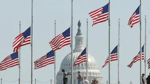 Getty Images Flags at half-mast in Washington DC on 2 October 2017