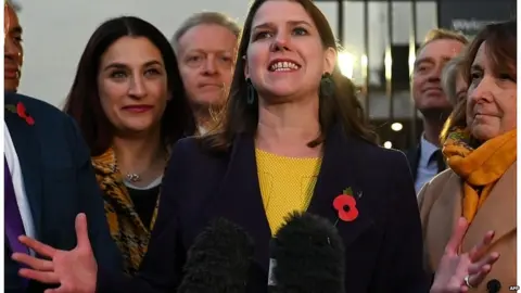 AFP Jo Swinson and other Lib Dem candidates outside Parliament