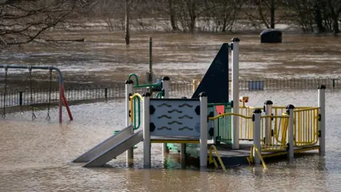 PA Media A children"s playground submerged by floodwater after the River Severn burst its banks at Bewdley in Worcestershire.