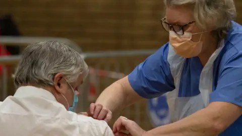 Getty Images A man gets a vaccine