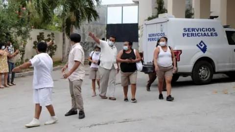 Reuters Hotel workers are seen at the entrance to a hotel after two suspected drug gang members were shot dead