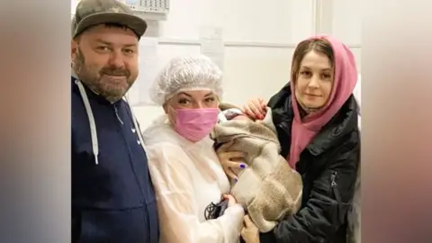 The Siberian Times Dmitry and Anna Litvinov with a medical professional holding the baby