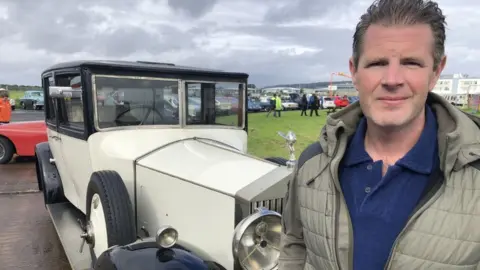 BBC Paul Curley standing next to a 1929 Phantom 2 Rolls Royce