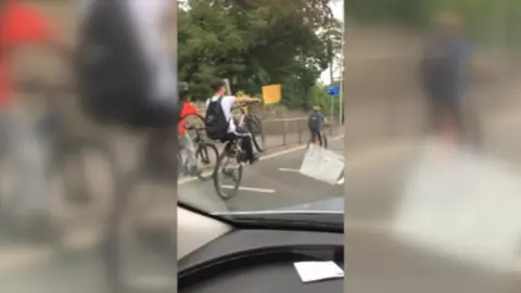 BBC Cyclists doing wheelies on North Road, Cardiff