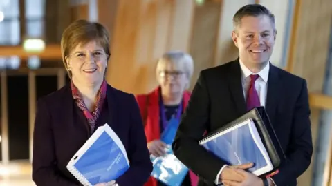 PA Nicola Sturgeon and Derek Mackay