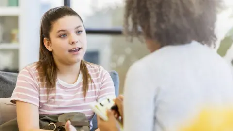 Getty Images picture of girl talking to adult