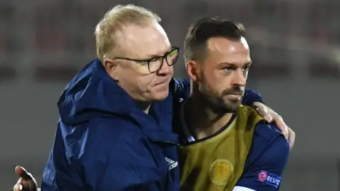 Scotland head coach Alex McLeish celebrates with Steven Fletcher