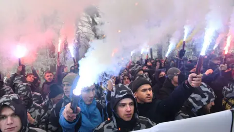 AFP Activists of Ukrainian far-right parties hold flares during a rally at the Ukrainian parliament
