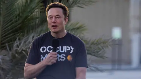 Getty Images Elon Musk wears an 'Occupy Mars' t-shirt at a T-Mobile and SpaceX joint event in Texas