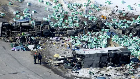 Canadian Press/REX/Shutterstock Aerial photograph of wreckage shows lorry's load scattered in the snow, highly damaged bus and overturned trailer