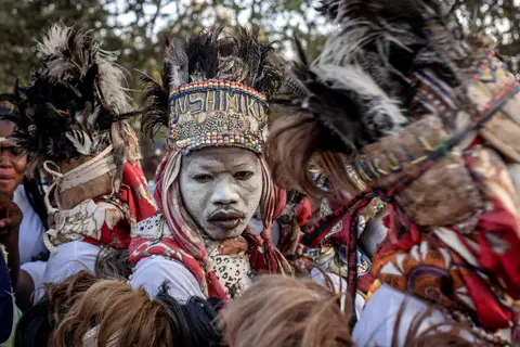 Guerchom Ndebo / AFP Traditional dancers perform as the remains of slain Democratic Republic of Congo independence hero Patrice Lumumba arrive in Shilatembo on 26 June 2022