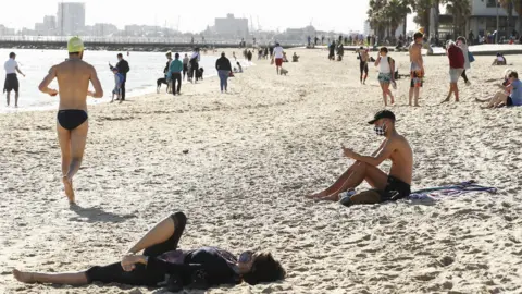 Getty Images Beachgoers wear masks during lockdown in Melbourne on 6 September 2020