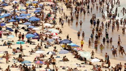 Reuters People basking in the sun at Sydney's Bondi Beach on a hot summer day in Australia, 7 January 2018