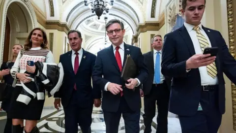 EPA Speaker Mike Johnson surrounded by aides