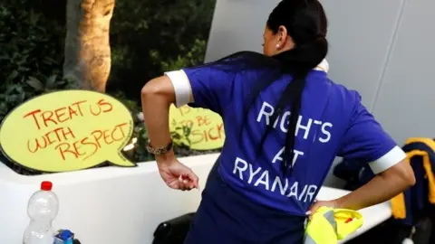 Reuters A striking cabin crew member at Frankfurt airport