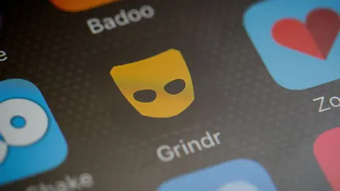 Leon Neal/ Getty Images Stock image of Grindr on phone screen