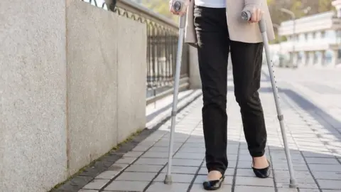 Woman on crutches