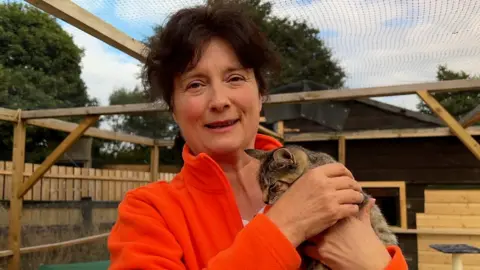 A woman holding a cat