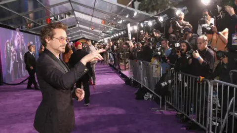 Getty Images Robert Downey Jr stands in front of photographers on the red carpet at the Avengers: Infinity War premiere in Los Angeles