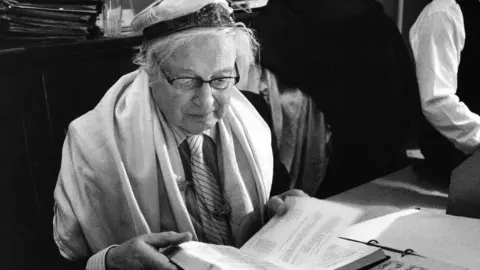 Nudrat Afza Rudi Leavor in a prayer shawl at the synagogue