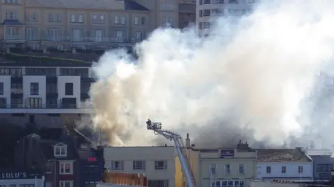 Neil Fleming Smoke billowing out of the rooftop