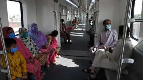 Getty Images Passengers ride a train on the newly built Orange Line Metro in Lahore