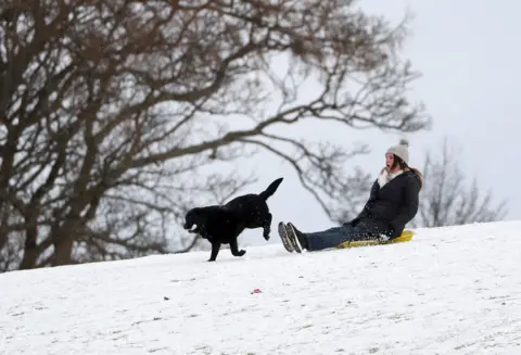 PA Media A person sledging in a snow covered Callender Park in Falkirk. Picture date: Monday February 8, 2021
