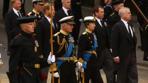 Reuters Members of the Royal Family walk behind the Queen's coffin