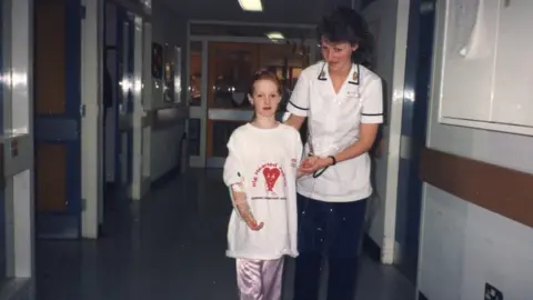 Michelle Crawford Michelle learning to walk again with nurse.