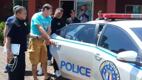 CRIME SUPPRESSION DIVISION/ ROYAL THAI POLICE This handout from the Crime Suppression Division of the Royal Thai Police taken on June 15, 2019 and released on June 16, 2019 shows Italian national Francesco Galdelli (C) after he was arrested on the outskirts of Pattaya.