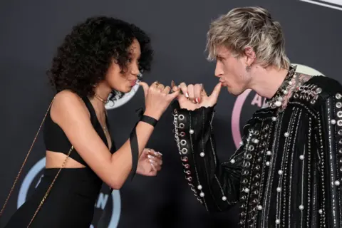 Getty Images Machine Gun Kelly and his daughter at the AMAs