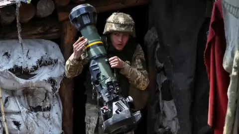 Reuters A Ukrainian service member holding a next generation light anti-tank weapon (NLAW) near the front line