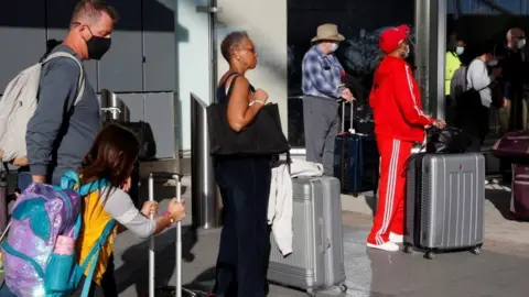 Reuters Travelers depart ahead of the Thanksgiving holiday during the coronavirus disease (COVID-19) pandemic, in Atlanta, Georgia